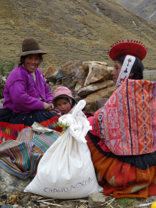 Martina from Chaullacocha, with a bag of food generously donated by the Reach Out Children´s Foundation. Martina's husband Antonio Rios is the President of the Parent's Association and key to the success of the food supplements.