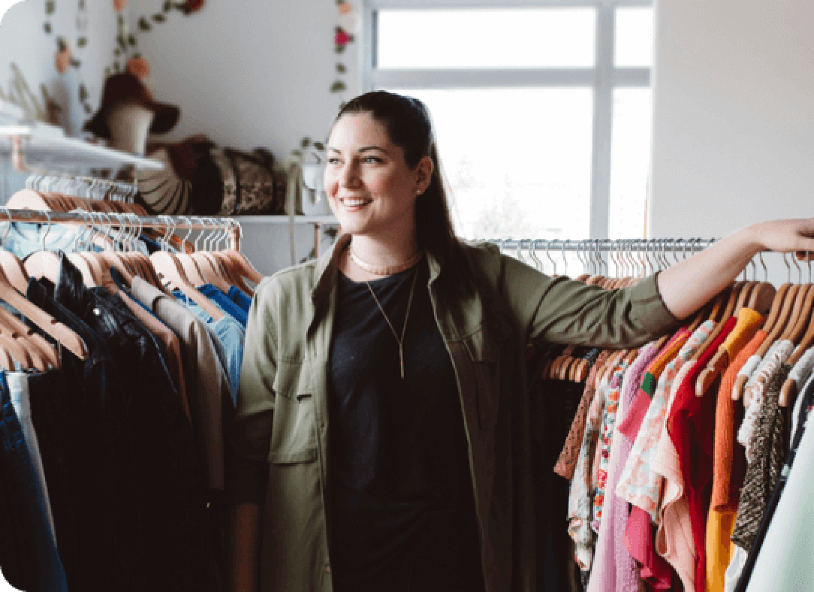 The owner of the clothing store smiles.