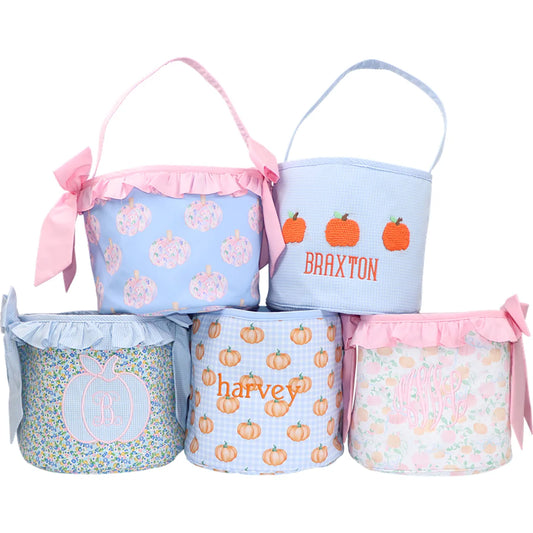Set of personalized fabric baskets with pumpkins and names on a white background