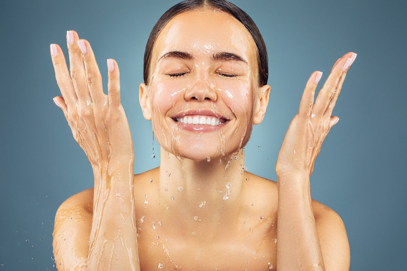 Woman washing face with ice water