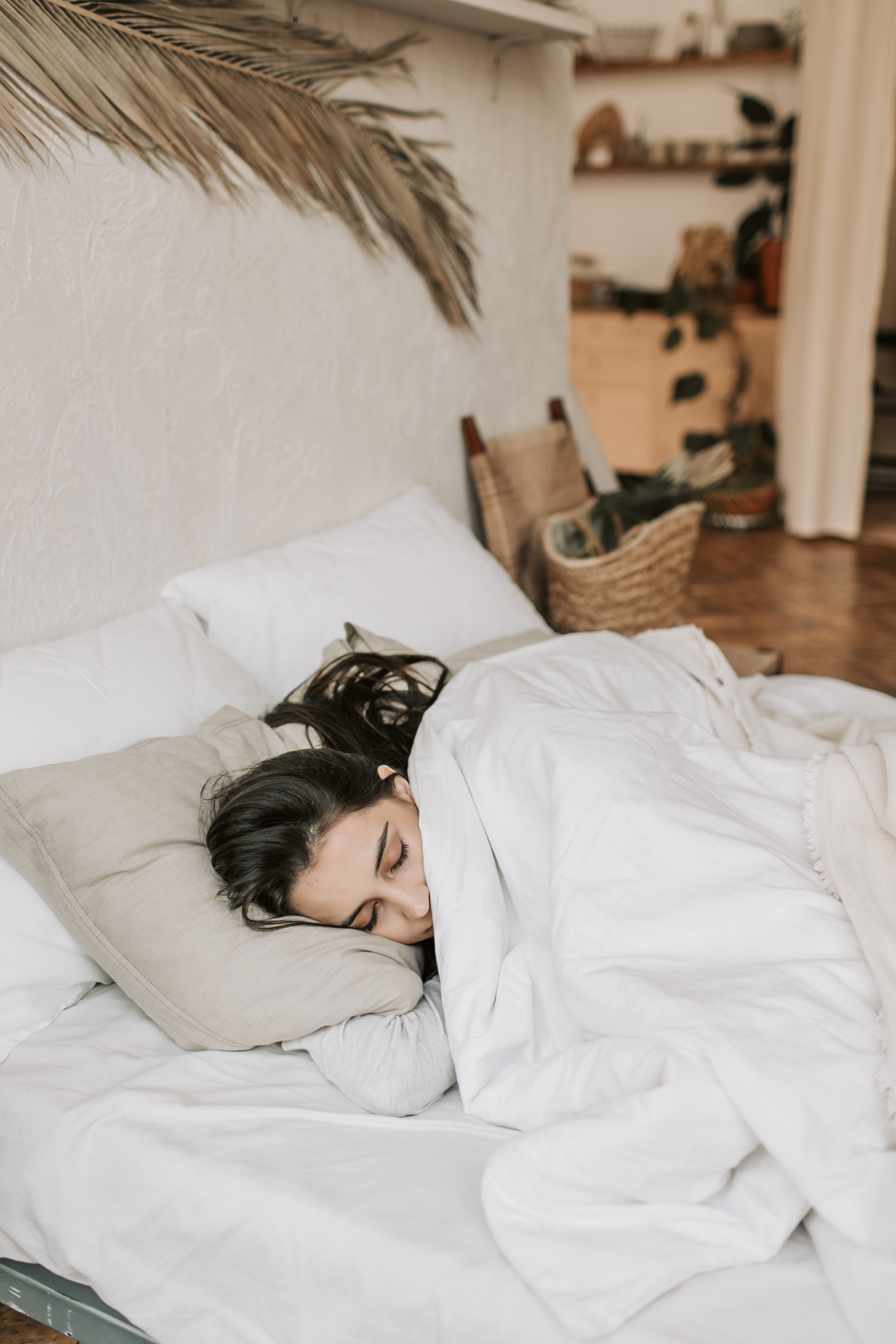 Woman sleeping on white sheets