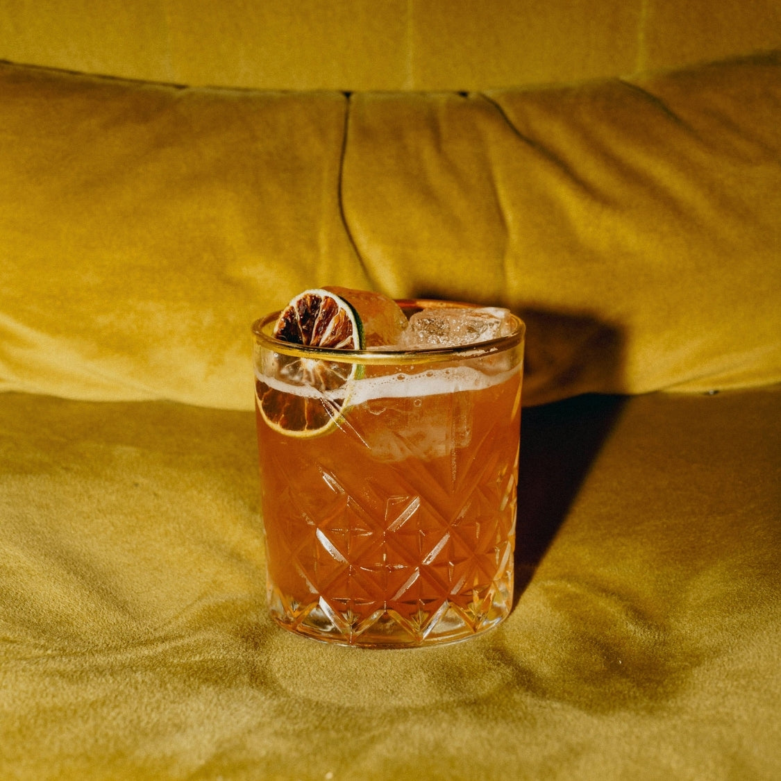 Negroni cocktail on a yellow sofa