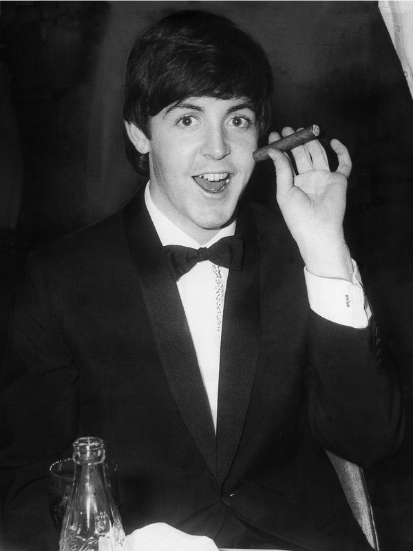 Paul McCartney with a cigar posters & prints by Associated Newspapers