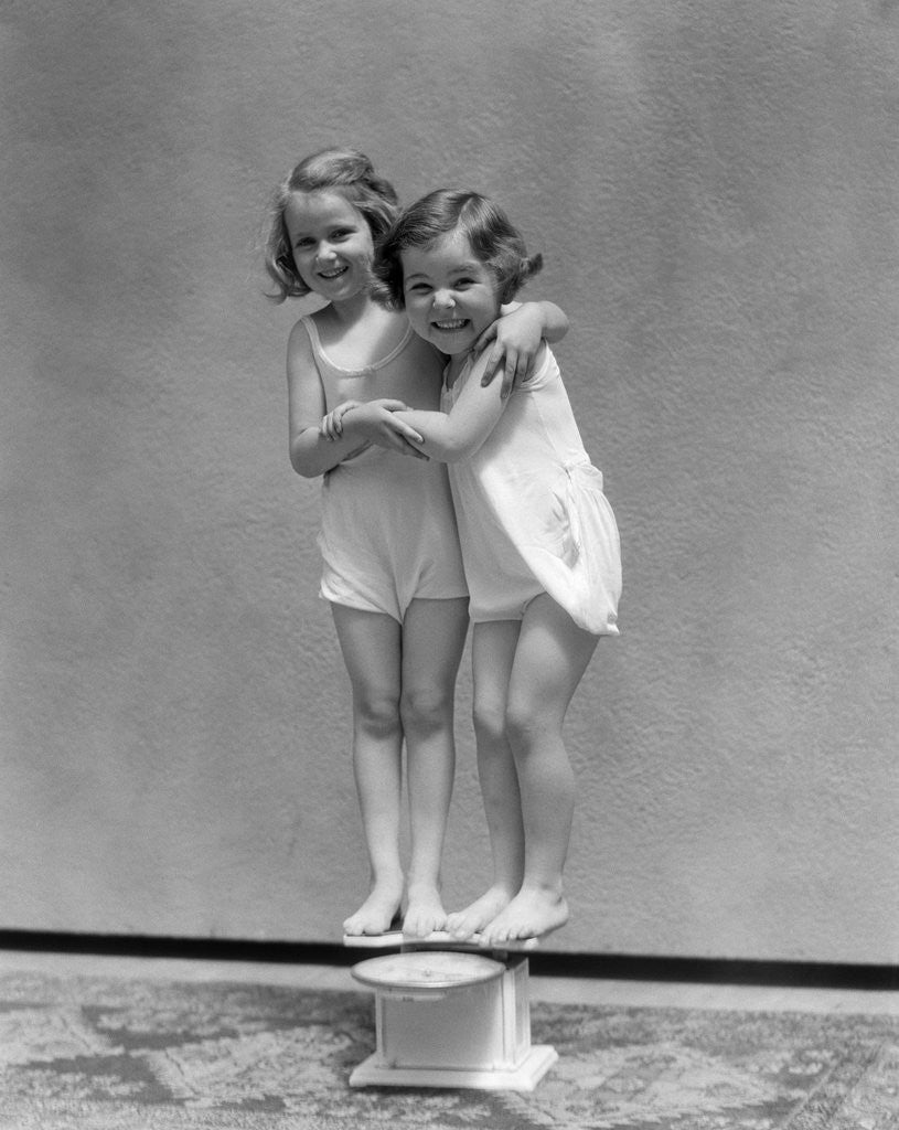 1930s Two Little Girls Standing On Scale Arm In Arm Smiling posters ...