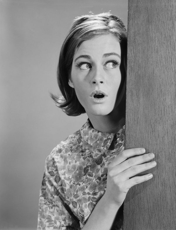 Woman Peeking Around Door Corner With Fearful Expression Posters And Prints By Corbis