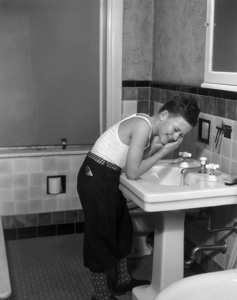 1930s Boy Washing Face At Bathroom Sink