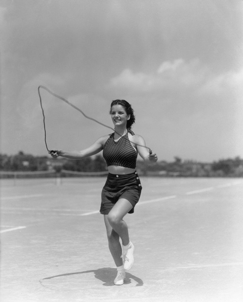 1930s woman jumping rope exercise outdoors wearing polka dot halter top ...