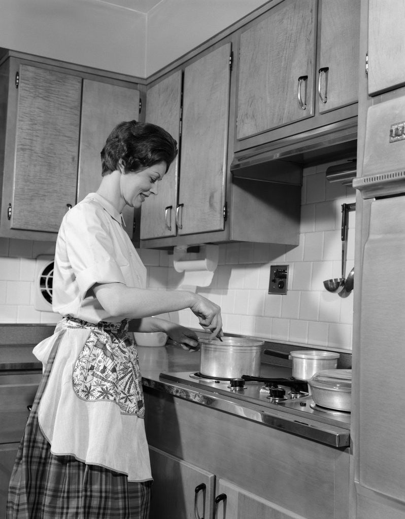1960s woman kitchen cooking stirring pot on stove posters & prints by ...