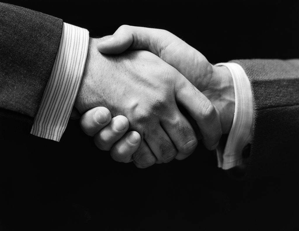 1930s close-up of businessmen's hands in handshake against ...