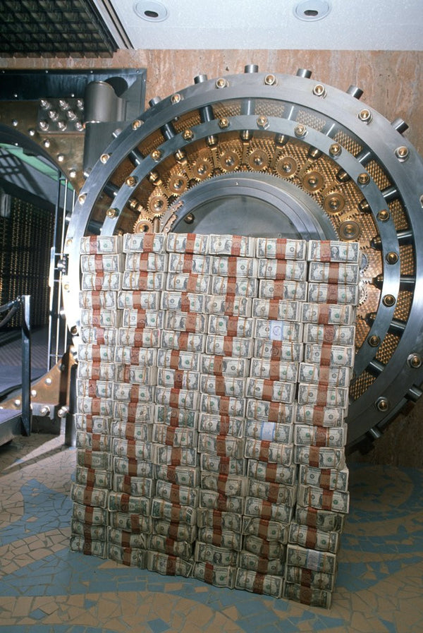 Money stacked by bank vault posters & prints by Corbis