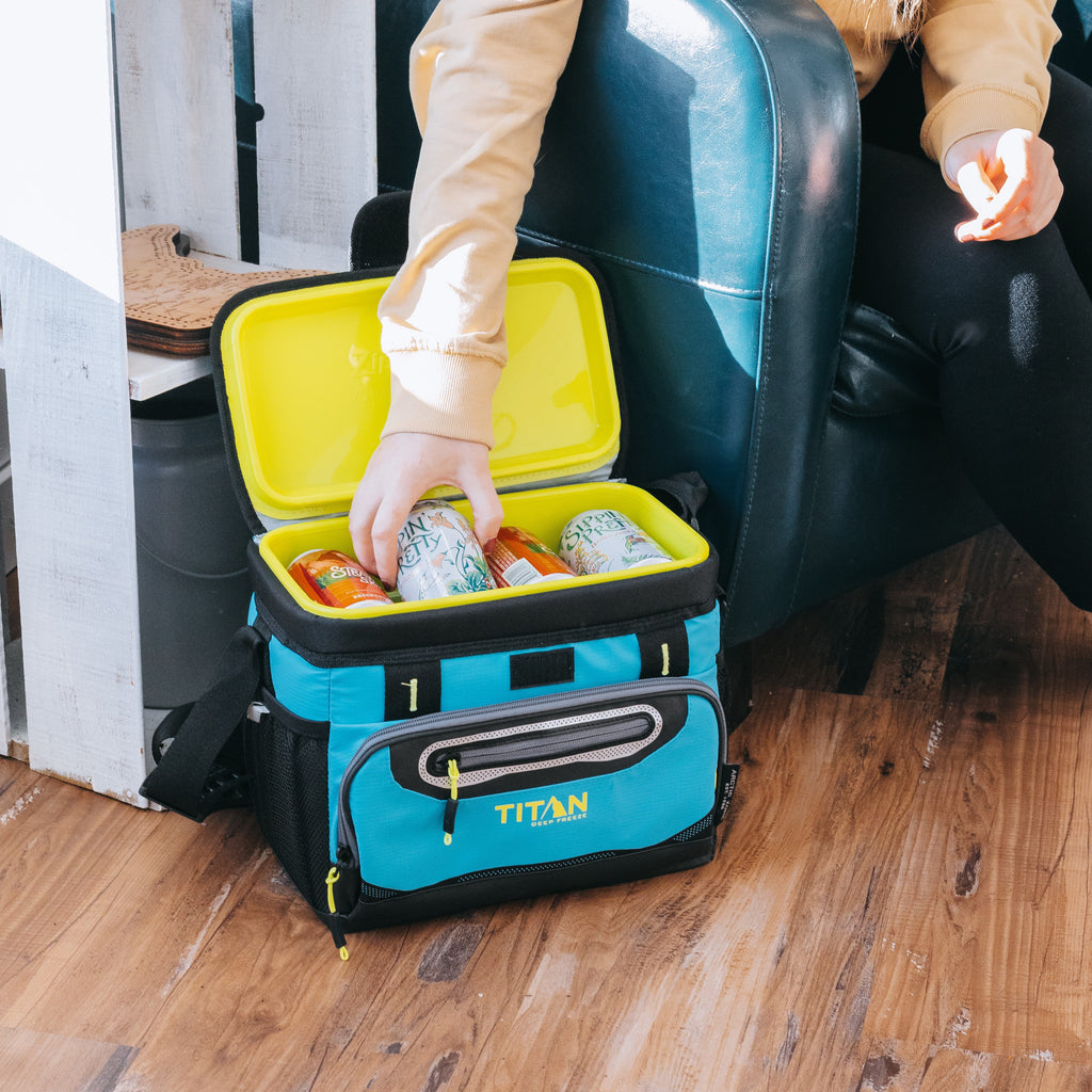 Person reaching into a cooler to grab a drink