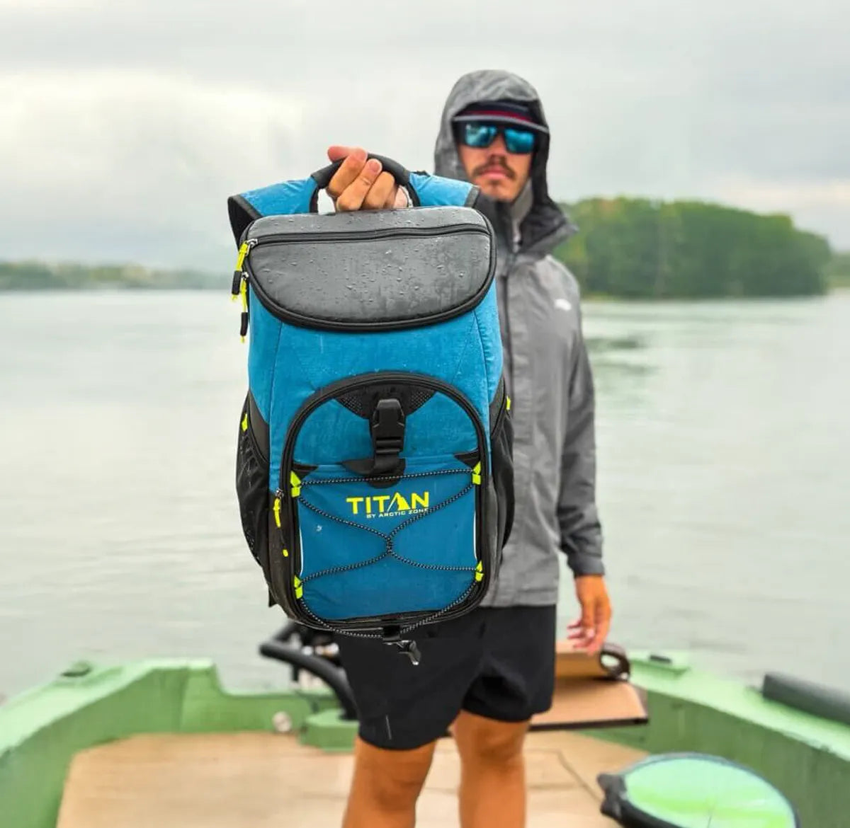 Guy holding up a Titan backpack cooler