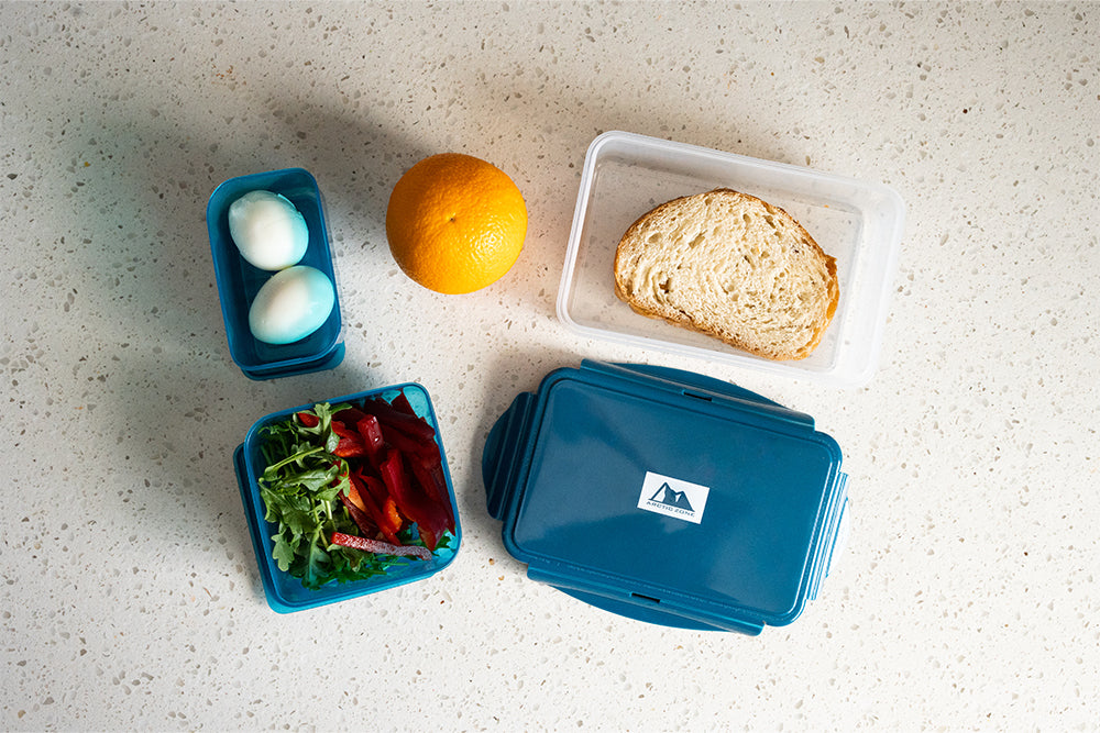 Arctic Zone® 8 Piece All-In-One Entrée Container Set prepped with food on a counter top.
