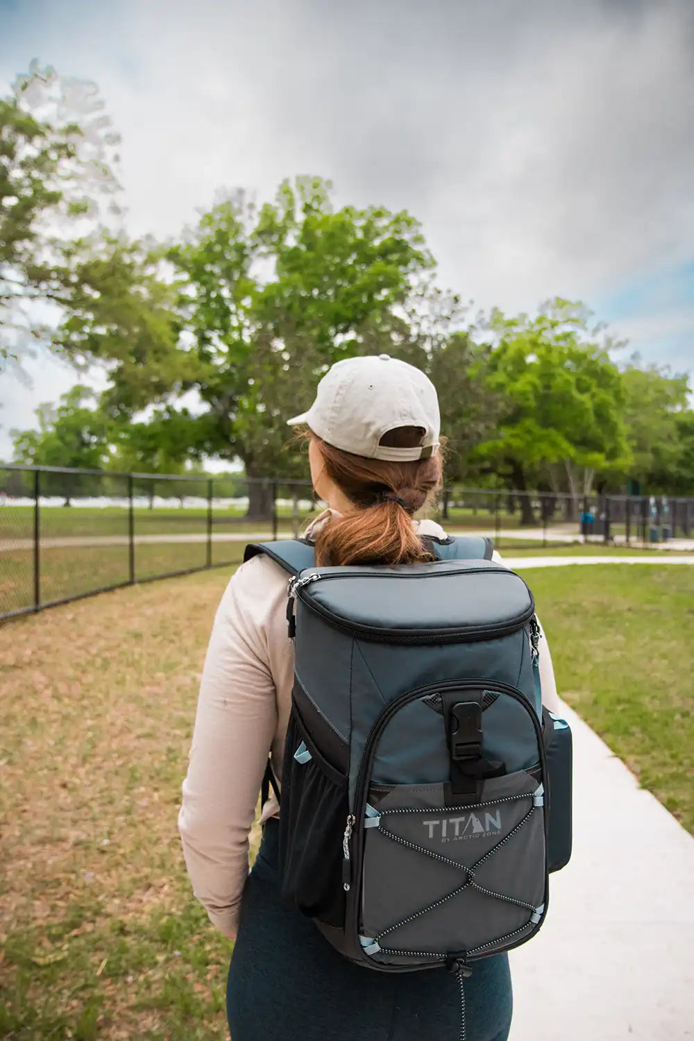 Girl wearing a backpack cooler while out on a walk