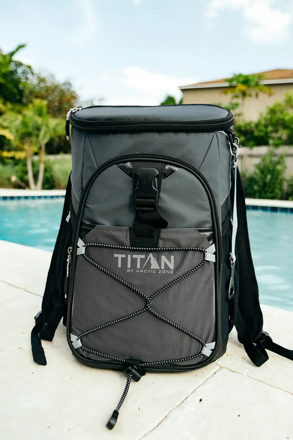 Backpack cooler outside next to a swimming pool