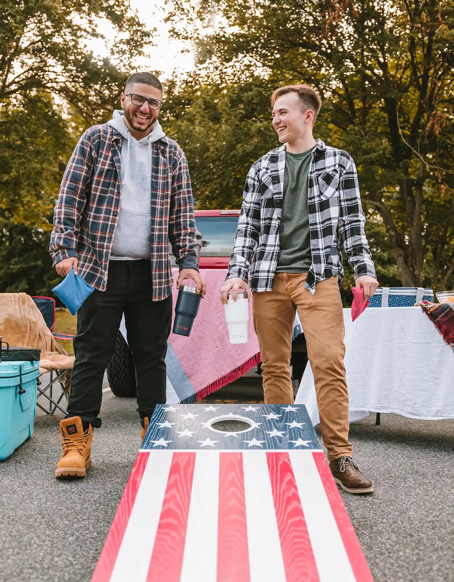 Two people play cornhole while celebrating Memorial Day
