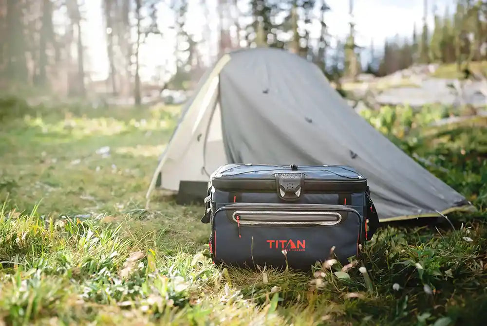 Titan 48 Can Zipperless Soft Cooler outside on the grass while camping