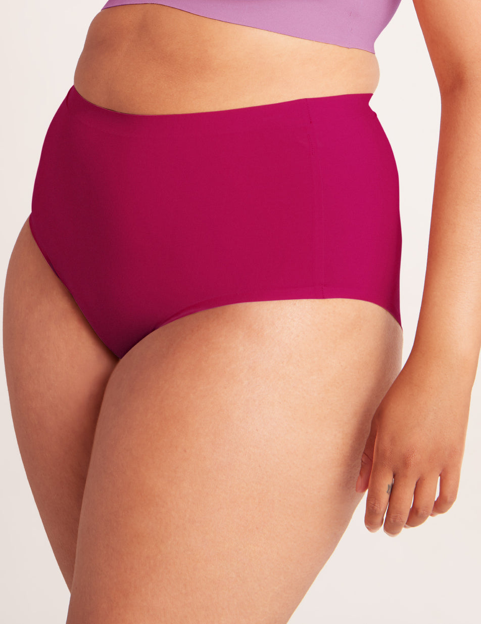 Gabi has 44" hips and wears Knix size L color:cerise