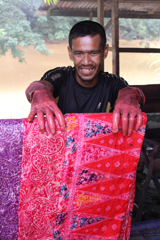 Batik artisan from Malaysia hand-dyeing fabric