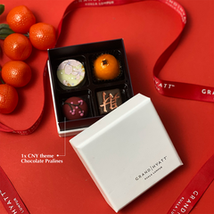 Chinese New Year collaboration between Grand Hyatt and Batik Boutique: Chocolate pralines elegantly displayed against a festive red background