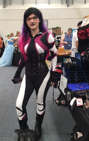 Cosplayer Hannah in her Gwen Stacy Spider-Gwen cosplay costume trying on a Gallery Serpentine lace corset at Goulburn Comic Con 2023