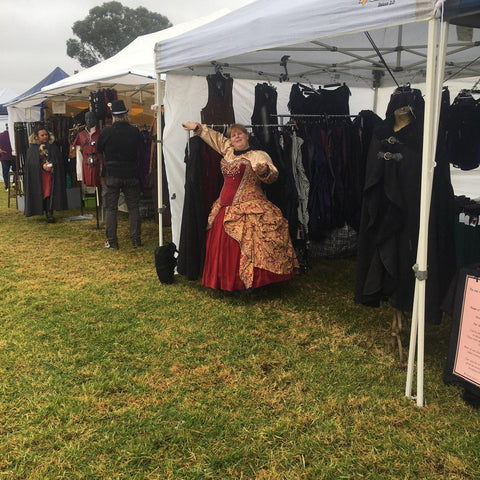 Nicole Kirkwood in her queenly gold and red corset gown ready to help lace people into corsets