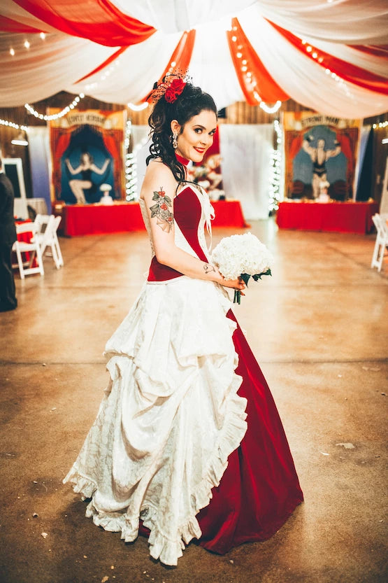 Julia in her Gallery Serpentine corset wedding gown in ivory and rich red velvet