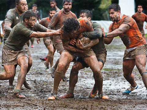 rugby team in mud