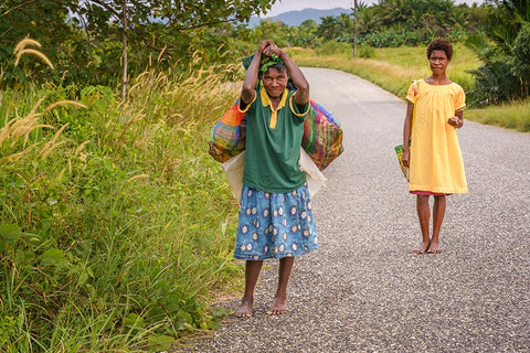 Ladies in Papua New Guinea carrying produce in locally crafted bilum bags
