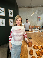 Kelli Parisian holding pain chocolate she made in pastry class in paris, chef in background