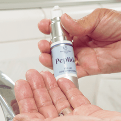 Woman's hand and fingers with Peptide Eye Gel on fingertips, Parisians Pure Skincare