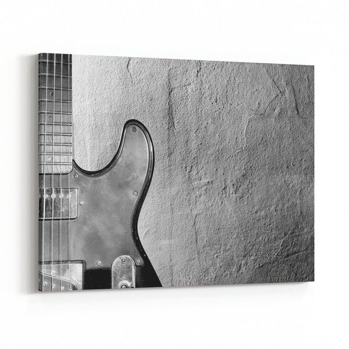 Black And White Photo Of An Elertric Guitar Near Wall Canvas Wall