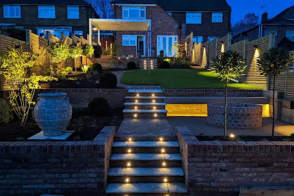 Landscaped garden with ascending steps, pathway and walls built on levels illuminated by in-lite 12 volt outdoor lighting installed throughout the landscape garden.