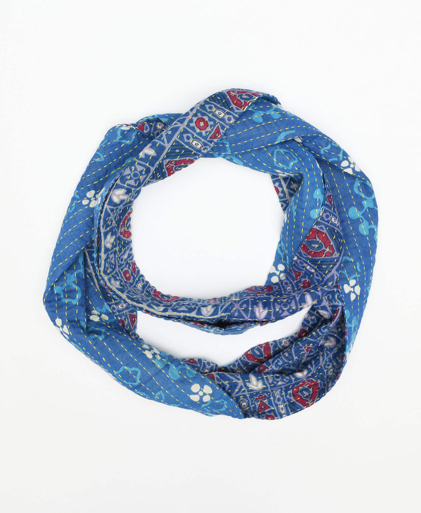 Bright blue colored cotton infinity scarf that has unique patterns