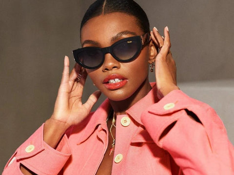A female model in a pink jacket wearing QUAY MAD CUTE Cat Eye sunnies