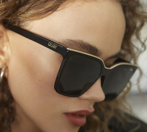 A side profile of a female model wearing QUAY LEVEL UP sunnies
