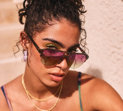 A female model wearing QUAY INTO IT tortoise sunglasses