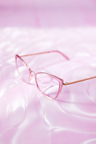 pink clear framed prescription glasses from QUAY on a pink background