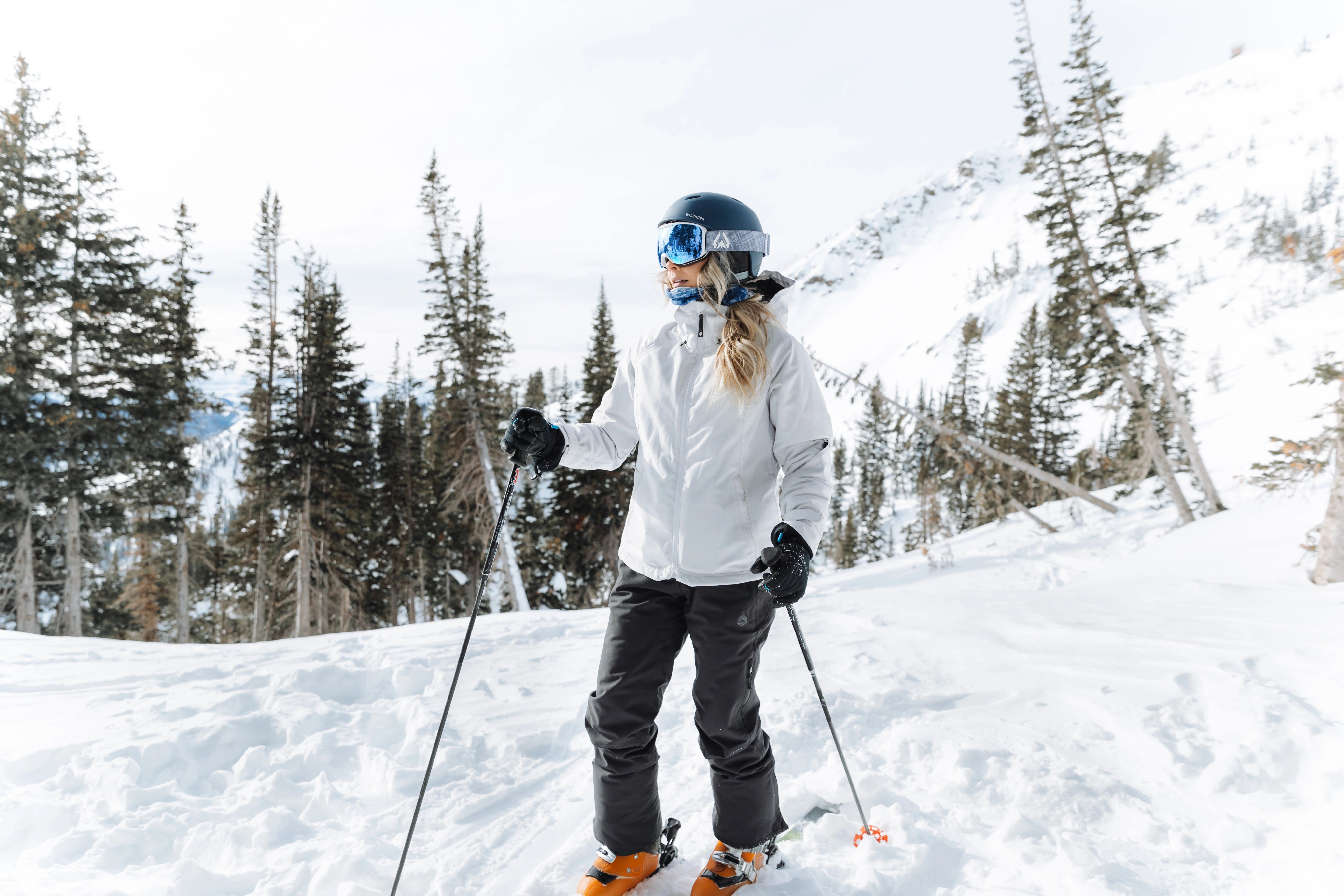 woman in snow gear skiing down a mountain