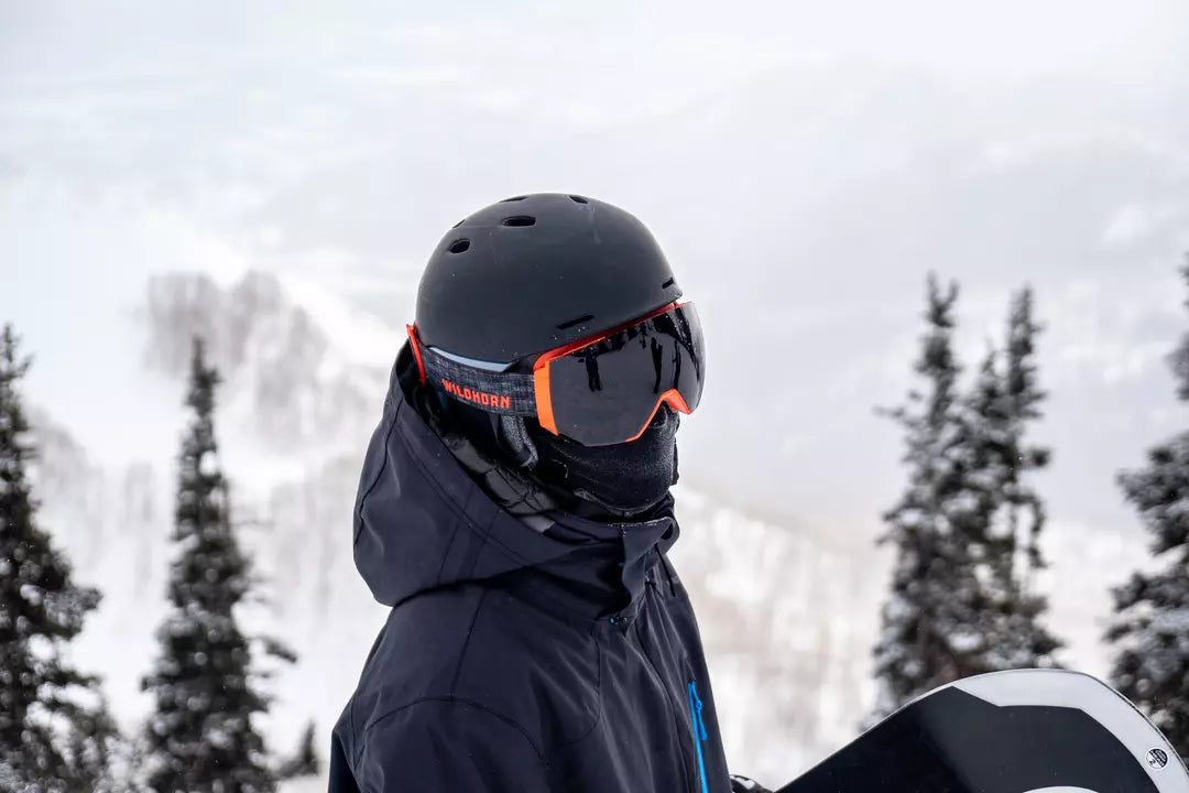 snowboarder on the mountain wearing Wildhorn’s Maxfield snow goggles