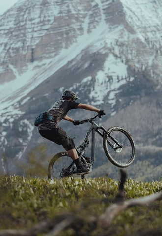 A man on a bike in a beautiful mountain setting