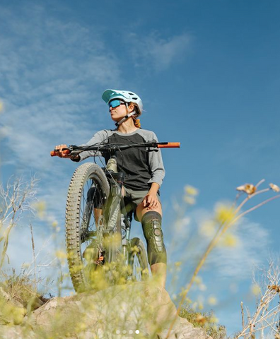 A woman on a bike with a Wildhorn mountain bike helmet