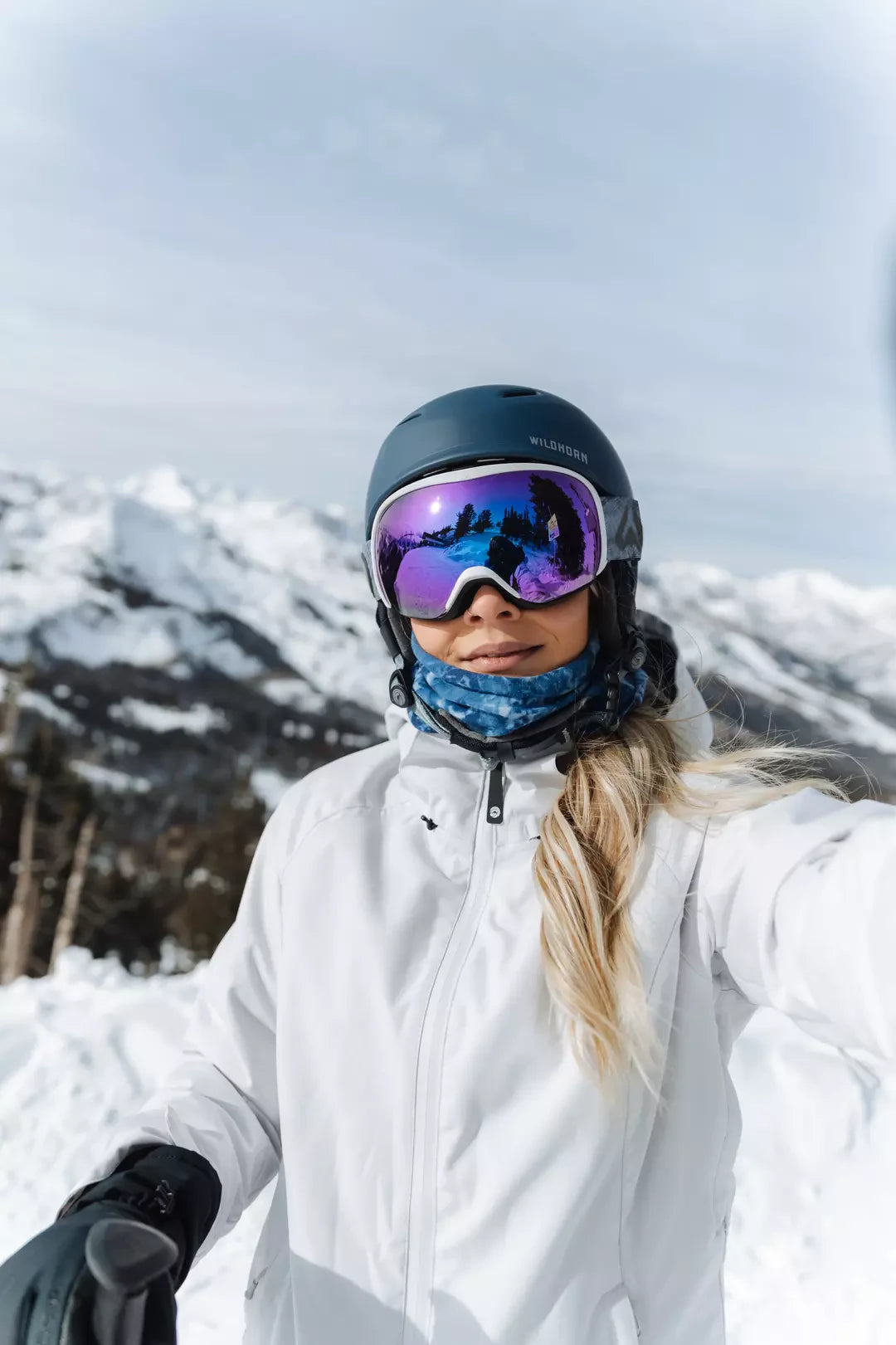 A woman on the slopes wearing a drift snow helmet