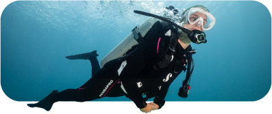 Scuba diver swimming underwater in clear blue sea.