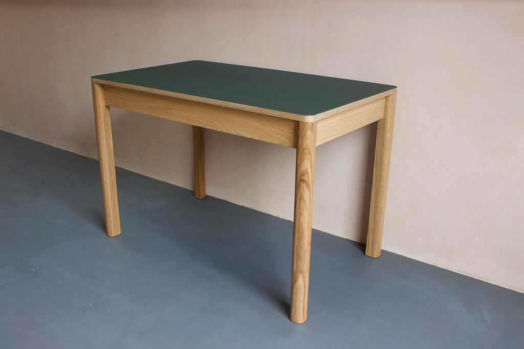 Contemporary Forbo linoleum table is perfect as a dining table or as a modern home office desk. It features Forbo linoleum top with solid oak legs. Choose from variety of Forbo furniture linoleum colour options. Designed and made by Jon Grant London in Leyton, East London.