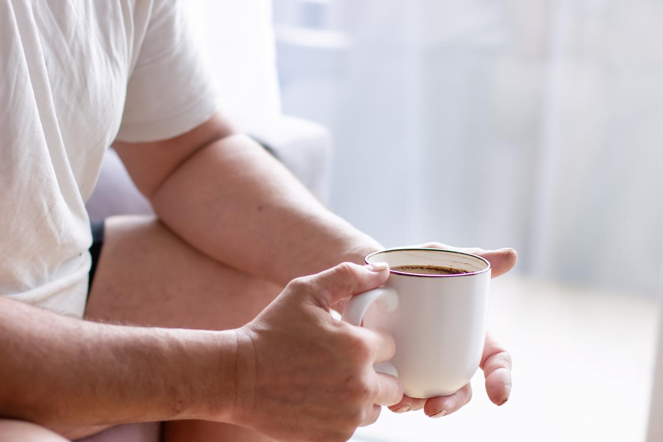 man holding a mug of cocoa quality supplement brand kidney function take l theanine supplements affect alpha brain waves green tea nutrition science stress management alert relaxation oolong teas