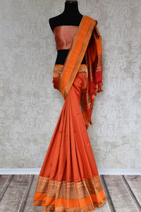 Buy elegant orange Banarasi silk saree with zari border online in USA. The saree is a stunning drape for an ethnic Indian look at weddings and special occasions. Find more such exquisite Indian silk sarees, handloom saris in USA at Pure Elegance Indian fashion store. Shop now.-full view