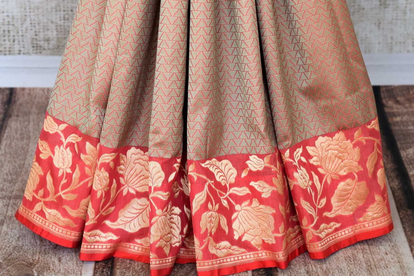 Endeavour into the enticing journey of beauty as you drape this cream floral embroidered banarsi silk saree. Style this sari with a graceful red and gold embroidered blouse as the intricate floral work steals the show. Shop designer sarees, embroidered saris, ikkat sarees online or visit Pure Elegance store, USA. -pleats