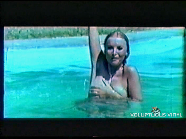 Barbara Bouchet covering breasts while in the pool in the film The Married Priest