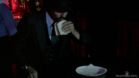 Limo driver drinking out of flask between two pieces of bread in Nightmare Weekend